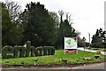 Enham Alamein: Topiary sign and the A343 through the village in Enham Alamein