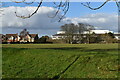 View across recreation ground to housing estate and hospital in DA2 6LY