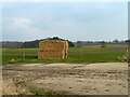 Straw bales by hardstanding, Boarded Barns Road in CM7 5DX