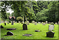 Lych gate beyond gravestones at the church of St. Michael & All Angels in Witton Gilbert