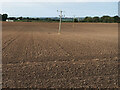 Arable field and power lines near Netherburn in ML9 3BS