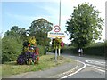 Flowers by Quarndon village sign in DE22 2JU