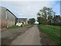 Minor road and farm buildings at Nisbethill in TD11 3HU