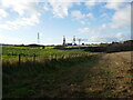Field boundary and view of the headstocks of the former Clipstone Colliery in NG21 9BG