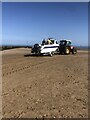 Tractor towing a boat out at Barkby Beach in LL19 7LG