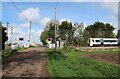 Train about to cross Cross Drove in CB25 9LW