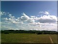 Puffy white clouds above a flat Bedfordshire landscape in MK43 0PP