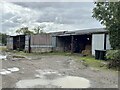 Barn in muddy farmyard in SY22 6SW