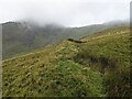 The ancient earthwork/wall on the slopes of Mynydd Perfedd in LL57 3DQ