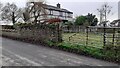 Field gate and Crosscanonby Vicarage on SW side of village road in Crosby (Cumberland)