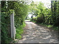 Looking along private road from Lock Stores Cottage towards Lock Lane in PO20 7BB