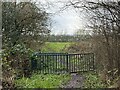 Metal kissing gate on muddy path in ST6 8HB