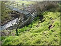 Metal footbridge, with some land-slippage above it in LL13 0BN