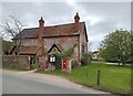 House and GR post box, Thursford Green in NR21 0RX