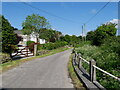 A Country lane, with cottage power and telephone line, and barrier for bridge in TR3 7AX