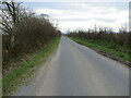 Hedge-lined minor road near to its crossing of Lancyking Beck in Holme Abbey