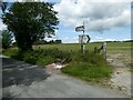 Road signs at a rural lane junction in LL20 7DB
