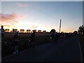 Dunwich Dynamo 2025 riders stop to admire the sunset in CM5 0EX