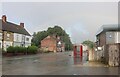 Downpour and rainbow on Main Road, Renishaw in Renishaw