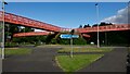 A roundabout & footbridges at the junction of Westbrook Way with Cromwell Avenue in WA5 8TQ