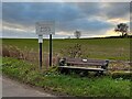 Bench and sign at the entry to Howell Wood Country Park in WF9 3EH
