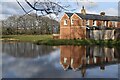 Cottage and reflection in pond at Pilley Bailey in SO41 5QP