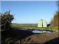 Field entrance view with silage bales in SN8 2DJ