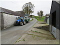 Minor road passing between farm buildings at Blaenau in SA19 8HJ