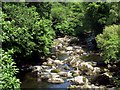 Youngsters scrambling on rocks in Afon Ogwen below Pont Bryn Bella bridge in LL57 3LU