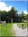 Standing stone and ancient cross in Mabe churchyard in TR10 9JF