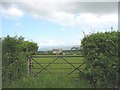 View across pasture land to Ty Gwyn farmhouse in LL60 6NN