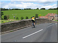 Cyclist crosses Kerne Bridge in HR9 6HZ
