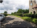 Road past All Saints, Wreningham, Norfolk in NR16 1AN