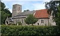 Looking over hedge to church at St James South Elmham in IP19 0HL