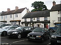 Cars parked in the middle of Dunster High Street in TA24 6SL