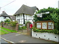 Parish noticeboard, postbox and road sign in OX11 9BD