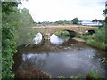 Looking up river to bridge (from footbridge) in NE61 2EU