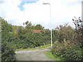 Red roofed shed at minor road junction in Llanddona village in Llanddona Community