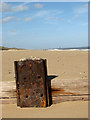 Rusty stump of a groyne in NR12 0EF